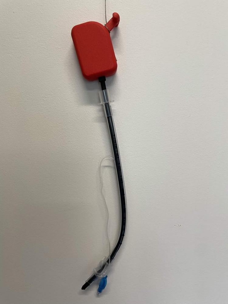 Final Prototype of the Maneuverable Stylet, Red hand control at top connected to proximal section followed by distal tip.