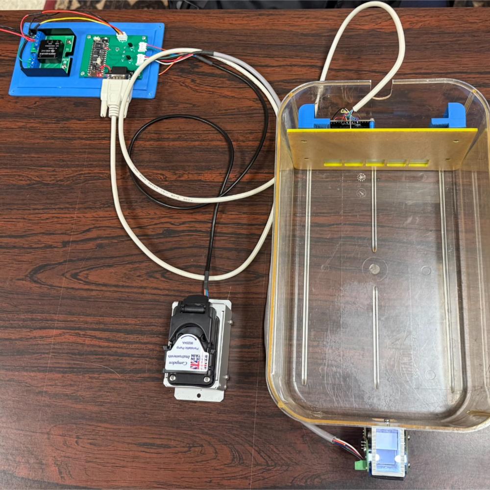 Image of training system and mouse enclosure. The PCB and feeder pump live outside of the enclosure, the magazine bolts one side, and the screen lives inside the enclosure behind a shield with five holes to allow the mice access.