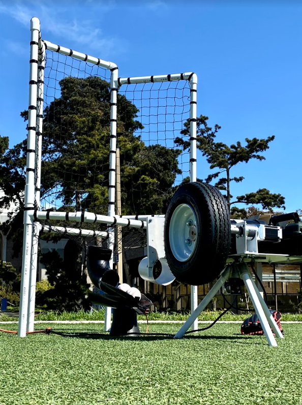 Picture of the baseball fielding machine on the field.