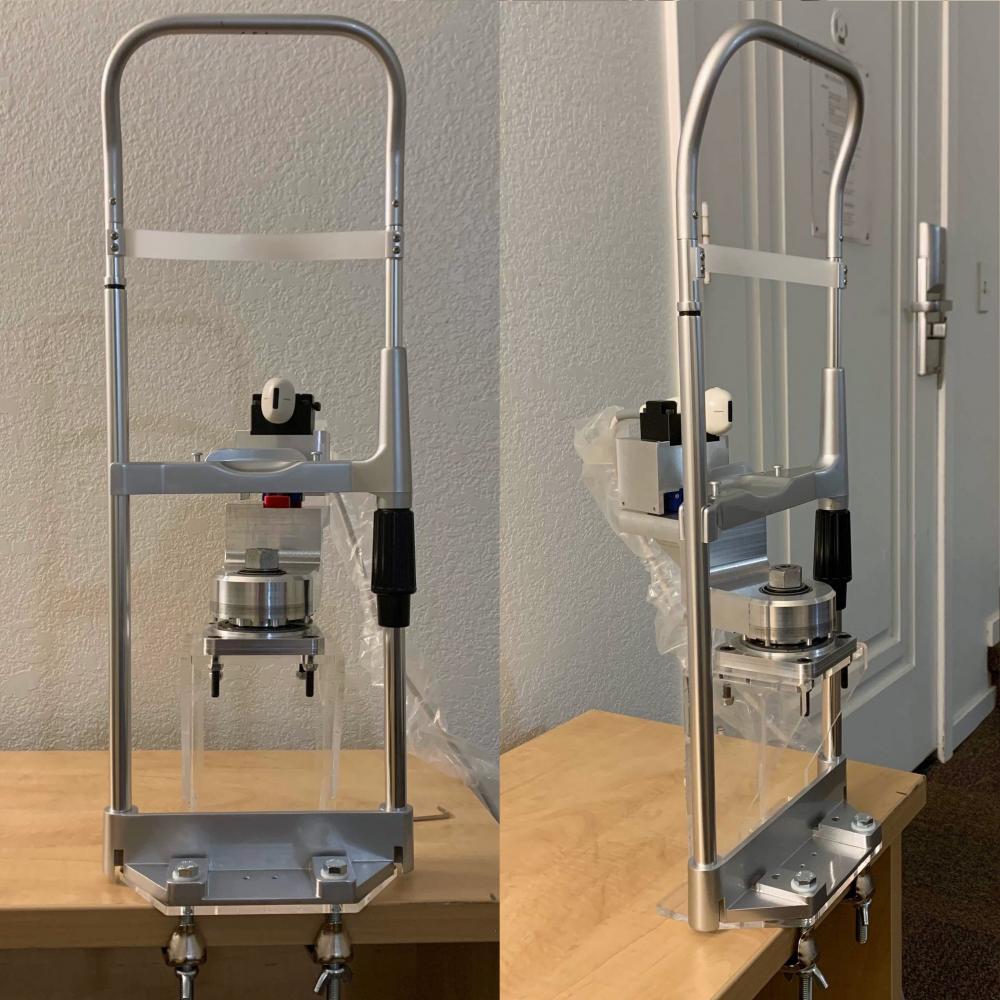 A front view and a 3/4 view of the ultrasound transducer guidance system  for dental imaging fixed to a table top. 